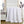 White silk comforter by HealthyLine, quilted with scalloped stitching, folded over a bed in a bright bedroom.