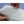 White, fluffy silk comforter filling by HealthyLine, held by hands showing its soft texture.