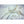 White silk comforter by HealthyLine, draped on a light surface with raw silk cocoons.
