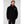 Black men's Dubliner jacket by Helly Hansen, with a high collar and white HH logo, worn over a maroon shirt and dark pants.