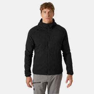 Black hooded insulator jacket by Helly Hansen with a front zipper, worn by a man in grey pants.
