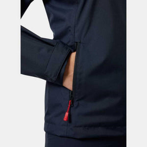 Navy blue Crew Jacket by Helly Hansen, cropped with hand in zippered side pocket with red pull tab and Velcro cuff.