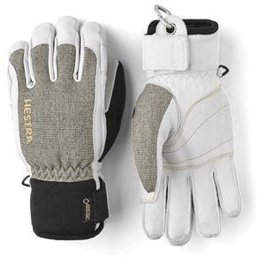 White leather and textile short gloves by Hestra, featuring textured grey panels, tan stitching, GORE-TEX logo, and a metal carabiner clip.