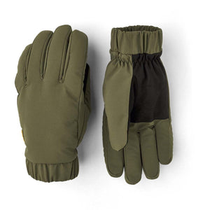 Olive green warming gloves by Hestra, showing a smooth back and a black quilted palm with elasticated cuffs.