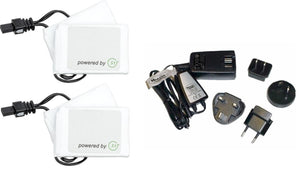 Black and white battery heating elements by Hestra, including two white SET-labeled packs and a Therm-ic multi-plug charger with international adapters.