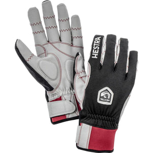 A pair of grey, black, and red Biathlon Trigger Comp gloves by Hestra, showing both palm and back views with logo.