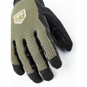 Olive green mesh 5-finger glove by Hestra with black fingertips, gold zig-zag stitching, and a brand logo patch.