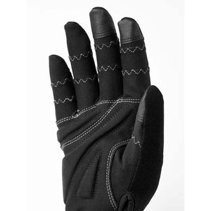 Black 5-finger glove by Hestra with white zigzag stitching, textured fingertips, and ergonomic palm padding, shown in a close-up palm view.