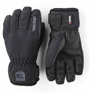 Black winter gloves by Hestra with textured palms, elastic cuffs, Velcro straps, and brand logos.