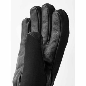Black leather and textile 5-finger glove by Hestra, shown in a close-up highlighting textured fingers and a smooth thumb.
