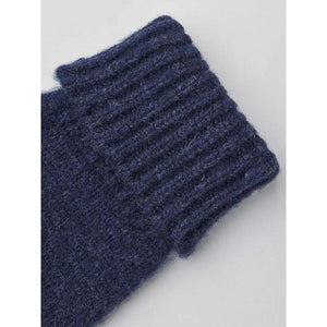 Dark blue wool mittens by Hestra, featuring a ribbed cuff and fuzzy, chunky knit texture.