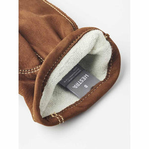 Brown nubuck leather men's glove by Hestra, showing the white knitted lining, exposed stitching, and a size 8 tag.