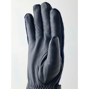 Dark blue elk leather men's gloves lined with cashmere by Hestra, shown in a side view with a pebbled texture.