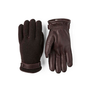 Men's dark brown elk leather and cashmere gloves by Hestra, with one glove featuring a knit back and the other entirely leather.
