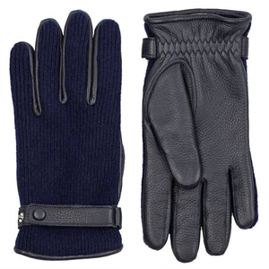 Dark blue knit and leather men's gloves by Hestra, featuring a leather wrist strap and pebbled leather palm.