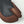 Two-tone leather 3-finger glove by Hestra, featuring a dark gray palm and brown finger sections, with an embossed logo.