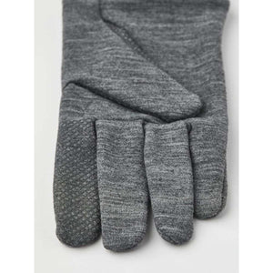 Thin grey 5-finger inner glove by Hestra, with textured grip on the thumb and index finger.