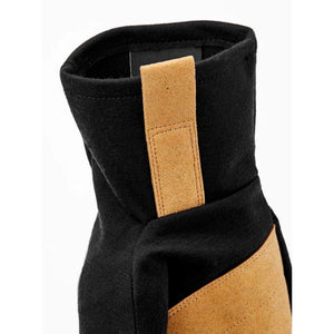 Black fabric glove by Hestra, showing the cuff with a tan suede strap and diagonal panel.