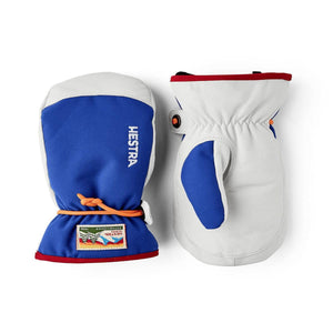 Pair of white and blue mittens by Hestra with an orange cuff cord, red trim, and logo patch.
