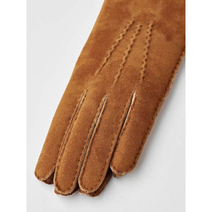 Brown suede women's gloves by Hestra with handswen stitching on the back and fingers, angled view.