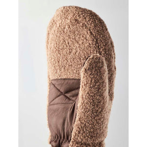 Tan fluffy and dark brown leather mittens by Hestra, with quilted detail on the palm and thumb, side view.
