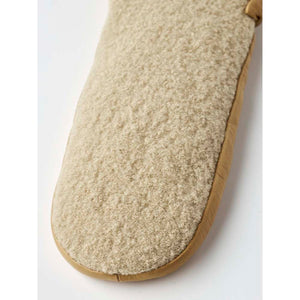 Fuzzy beige mitten by Hestra with tan leather trim, close-up.