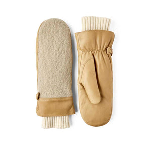 Tan leather mittens by Hestra featuring beige wool lining, ribbed knit cuffs, and adjustable button straps.