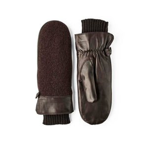 Dark brown leather and wool mittens by Hestra, featuring ribbed knit cuffs and buttoned leather straps.