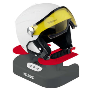 Dark grey boot, helmet, and glove dryer by Hotronic with red drying arms and a white ski helmet with a yellow visor resting on top.