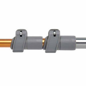 Trekking pole connector in dark grey, metallic orange, and silver by Kelty, showing the adjustable locking mechanism.