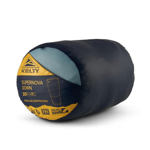 Dark blue 20F/-7C down sleeping bag by Kelty, compactly rolled, with a yellow label showing 550 fill and light blue interior.