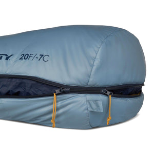 Light blue down sleeping bag by Kelty with a black zipper, orange pull cords, and "20F/-7C" text.