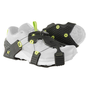 Black and lime green Winter Ice Runner by Korkers, featuring a Boa dial and textured sole, worn on a white sneaker.