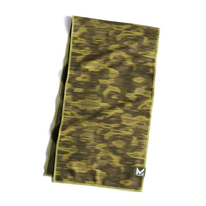 Camouflage patterned cooling towel by Mission, featuring horizontal stripes in olive and lime green with a small brand logo.