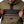 Olive green and black Men's Denali Anorak 1/4 Zip Heated Hoodie by Mobile Warming, featuring a front chest flap and lower zippered pocket, worn by a man.