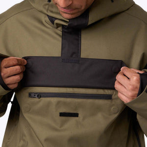 Olive green and black Men's Denali Anorak 1/4 Zip Heated Hoodie by Mobile Warming, featuring a front chest flap and lower zippered pocket, worn by a man.