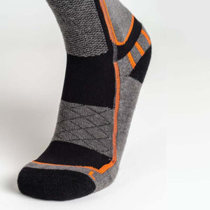 Men's gray, black, and orange heated knit sock by Mobile Warming featuring varied textures, a diamond pattern, and orange stripes, side view.