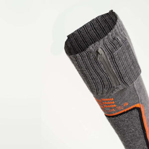 Grey merino heated sock by Mobile Warming with orange stripes and a small zipper pocket at the cuff.