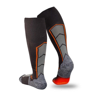 Black compression heated socks by Mobile Warming with gray geometric panels, orange accents, and textured soles with red heating elements.