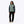 Women's sage green and teal hybrid heated jacket by Mobile Warming with quilted diamond pattern, worn with black cargo pants and beige sneakers.