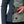 Dark teal and quilted sage green heated jacket by Mobile Warming, with a hand removing a power bank from an open pocket and a red N logo.