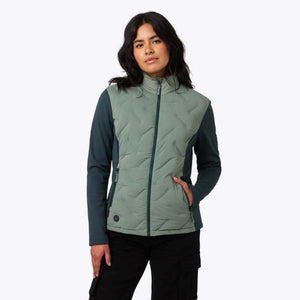 Women's Aria Hybrid Jacket by Mobile Warming, with a sage green quilted front, dark teal sleeves, and full-zip closure, worn by a model.
