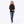 Black 1/4 zip long sleeve mock neck shirt by Mobile Warming, with a ribbed texture, worn by a woman with blue jeans and sneakers.