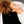 Black Cool Pad by Onyx Cool with textured circular patterns and 'ONYX' text, used by a person with curly hair wearing a white striped shirt.