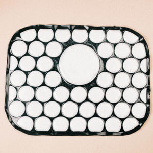 Black rectangular Onyx Cool Pad by Onyx Cool featuring a large central white circle surrounded by smaller white circles.