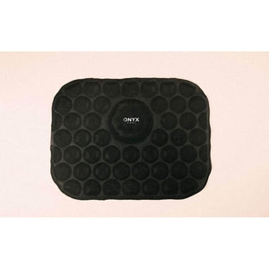 Black cool pad by Onyx Cool, rectangular with rounded corners, featuring circular raised bumps and a central brand logo.
