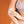 White oval cooling patch by Opal Cool being applied to an arm, worn with a grey sports bra.