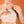 Light gray textured cooling pad by Opal Cool being inserted into a light pink sports bra.