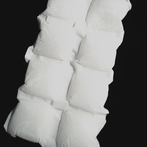 White segmented Cooling Paks by Oro Sports in a rectangular sheet, filled with granular material on a black background.