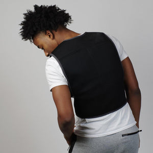 Black mesh cooling vest by Oro Sports, with grey trim, worn on a person's back over a white t-shirt.